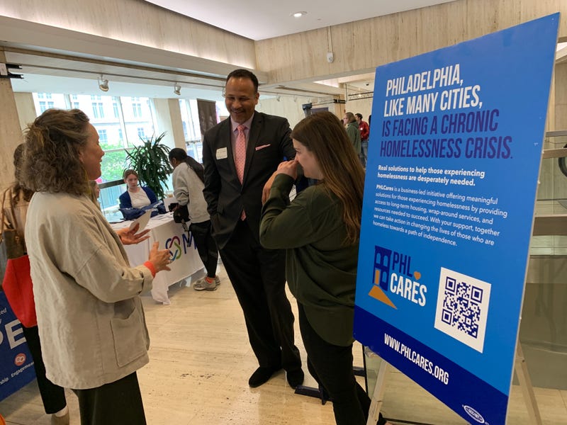 Liz Hersh (left) of the City of Homeless Services speaks with SEPTA’s Ken Divers (center) at SEPTA headquarters.