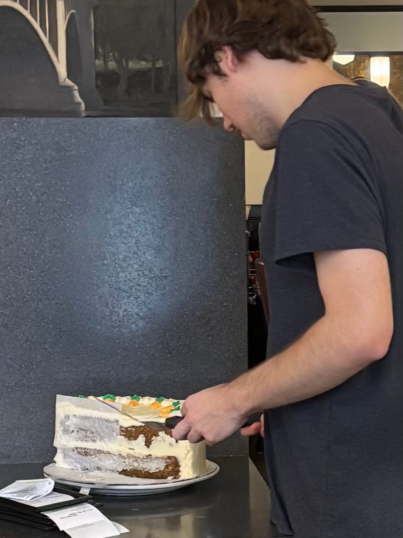 A Keys employee cutting another slice of carrot cake during their last day in business.