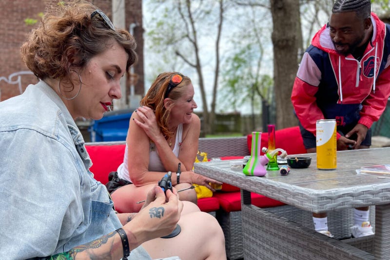 A group relaxes April 20 during the Green Light District Cannabis Crawl in St. Louis.