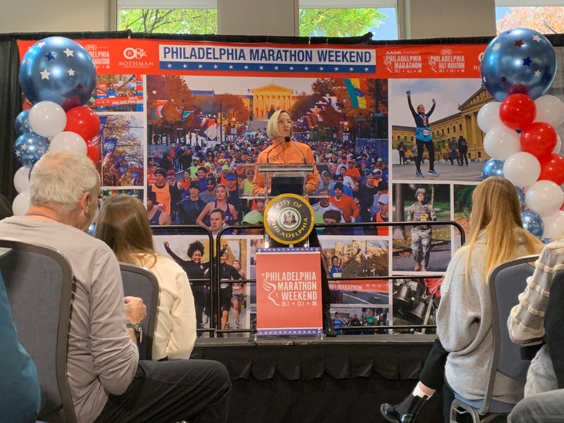 Kathleen Titus stands behind a stadium on Friday, Nov. 21, to preview the 2025 Philly Marathon