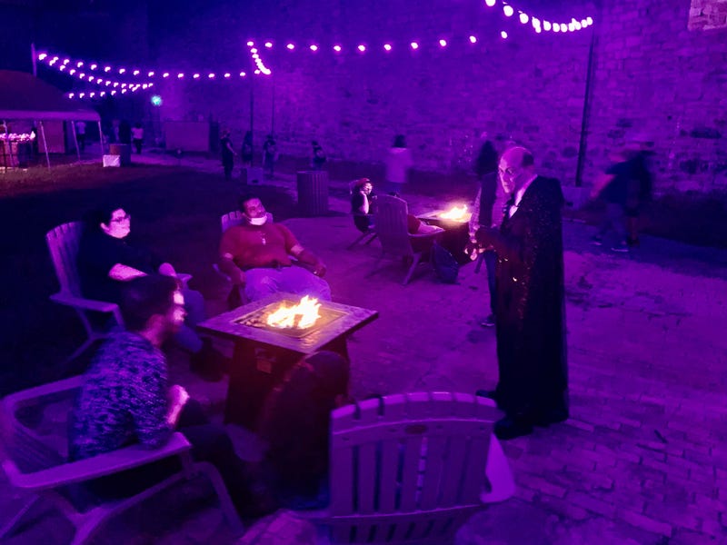 Visitors at Eastern State's Halloween Nights interact with a performer.