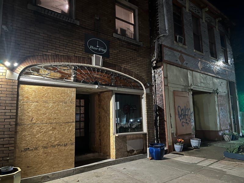 Bar:PM boarded up after police crashed into the front of the building.