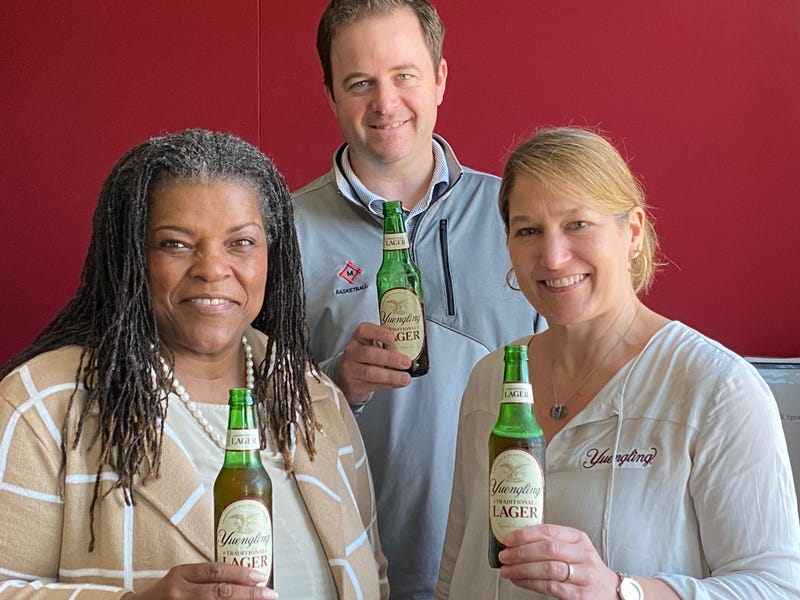 wendy yuengling, tom ackerman and carol daniel stand holding yuengling beers