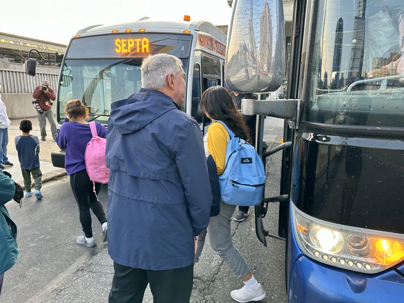 A bus of migrants sent from Texas arrives at Philadelphia's 30th Street Station on May 10, 2023.