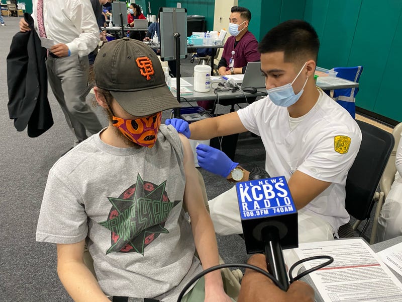 Alexander Steinhouse gets his second Moderna shot at the Kaiser Permanente/USF Nursing School COVID-19 vaccine clinic at the USF gymnasium