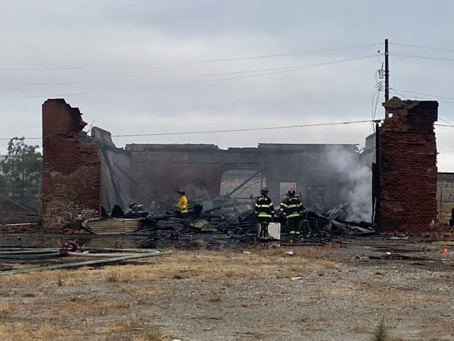 San Jose firefighters survey the wreckage after putting out the flames at a historical building.