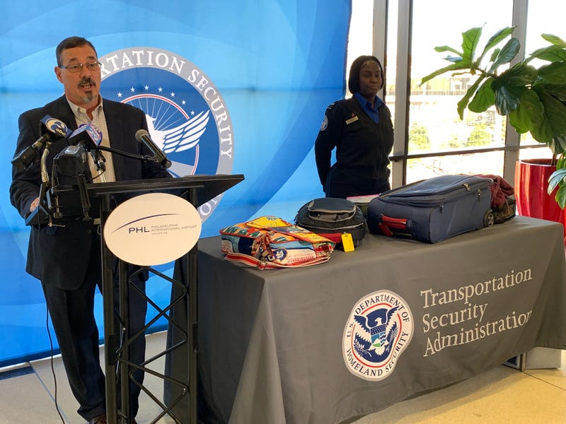TSA Federal Security Director Gerardo Spero (left) and officer Jamiella Everett discuss packing advice for travelers going through airport security.