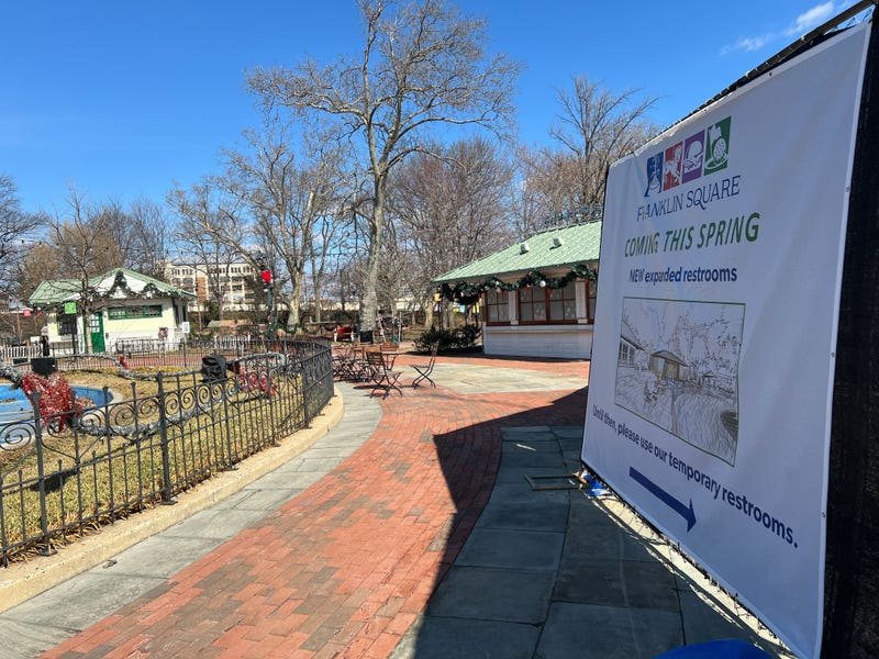 A banner hanging at Franklin Square Park touts expanded restrooms due to open in the spring.