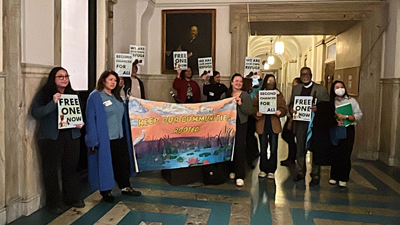 City Councilmembers Nicholas O'Rourke, Rue Landau and Curtis Jones Jr. join with immigration activists outside of Council chambers to call for ICE to release Sereyrath Van from custody.