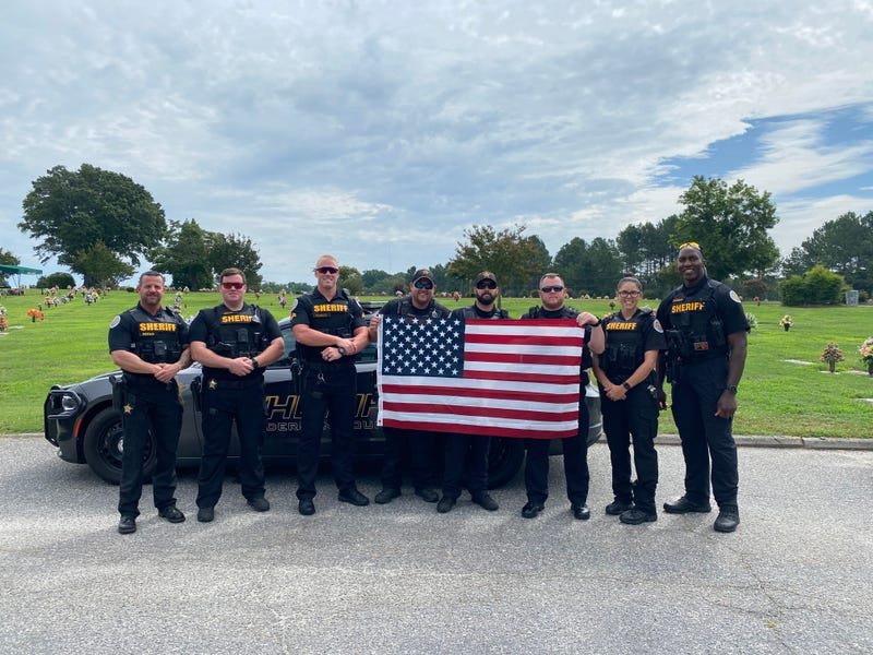 Anderson County Sheriff's Deputies replace flags vandalized at Anderson cemetery.