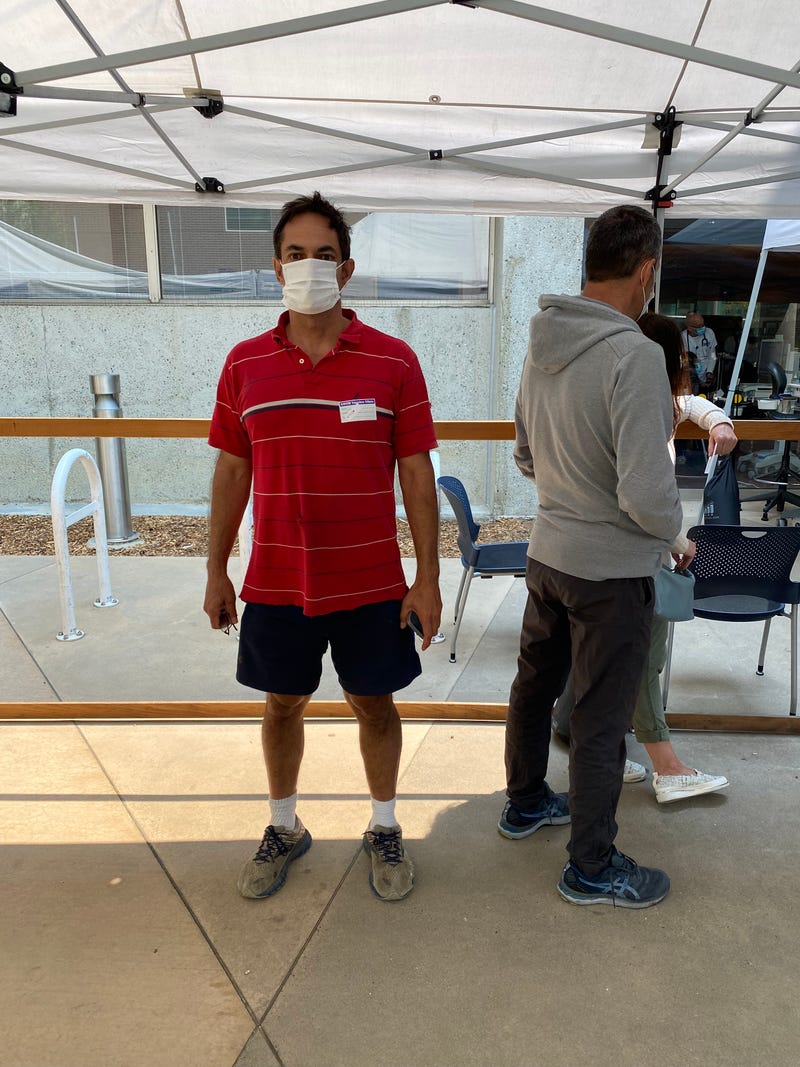 Esteban Torres waiting to get a booster shot.