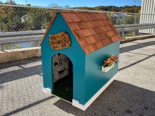 This dog house, with wooden shingles and dog wallpaper, will benefit Alex's Lemonade Stand foundation.