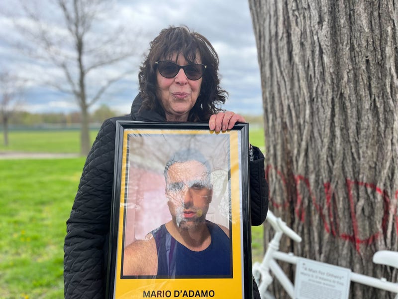 Paula D'Adamo hold a picture of her son, Mario, who was killed while riding his bike last summer in FDR Park.
