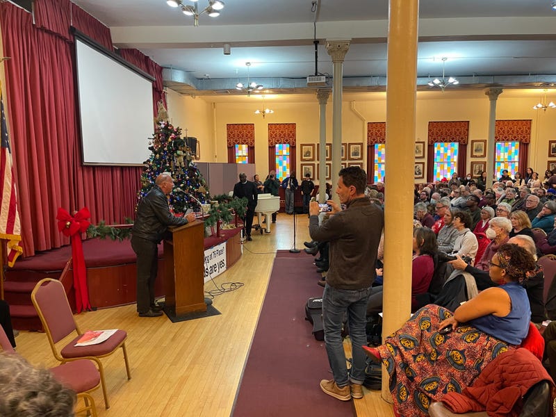 Councilmember Mark Squilla (at podium) discusses the proposed 76ers arena at a community meeting on Dec. 17, 2023.