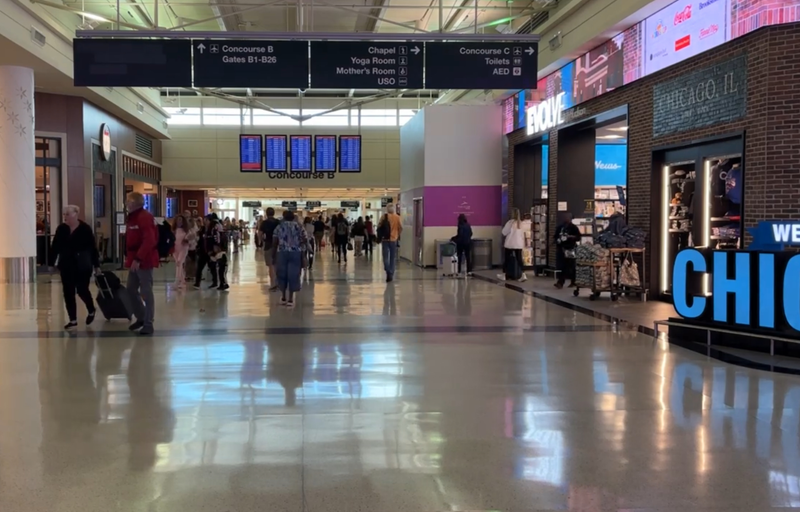 Travelers walk through Midway International Airport in Chicago.