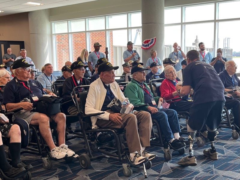 Doc Jacobs speaks to a WWII veteran on Wednesday
