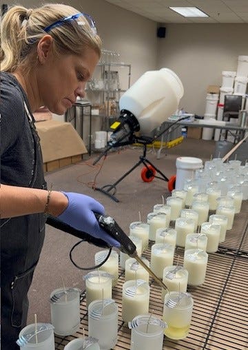 Woman worker assembling candle