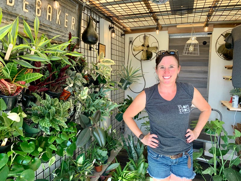 Gina Marie Houska stands in front a wall of foliage in The Plant Truck 