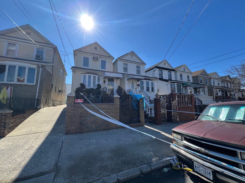 Police are investigating the death of a woman who was found lying on her front lawn in Ozone Park.