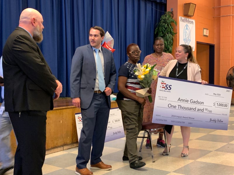Annie Gadson (holding flowers) is honored as the region’s top sub during a ceremony Tuesday at Robeson High School.