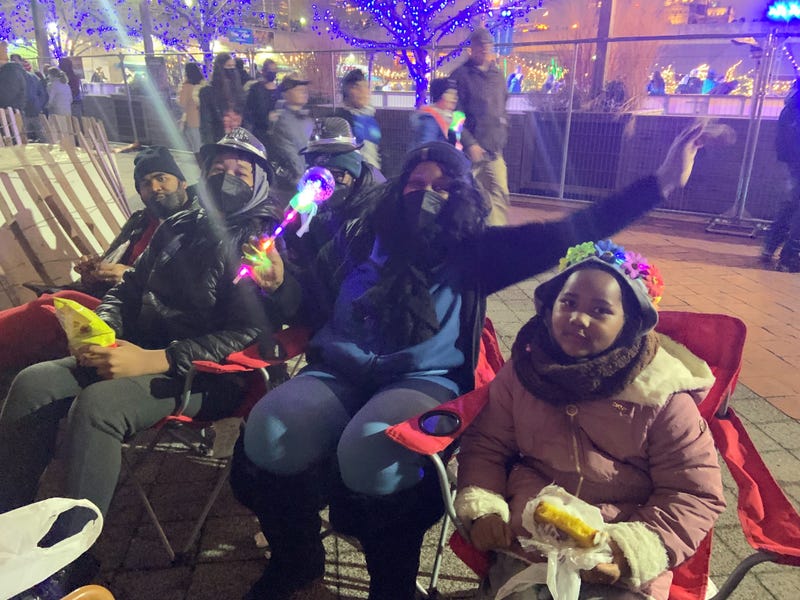 A family enjoying the New Year's fireworks at Penn's Landing.