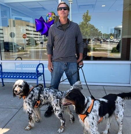 Paul Reasoner and his two bird hunting dogs