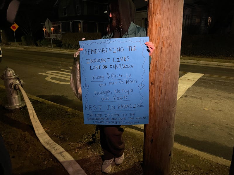 A sign brought to the scene to help serve as a makeshift memorial