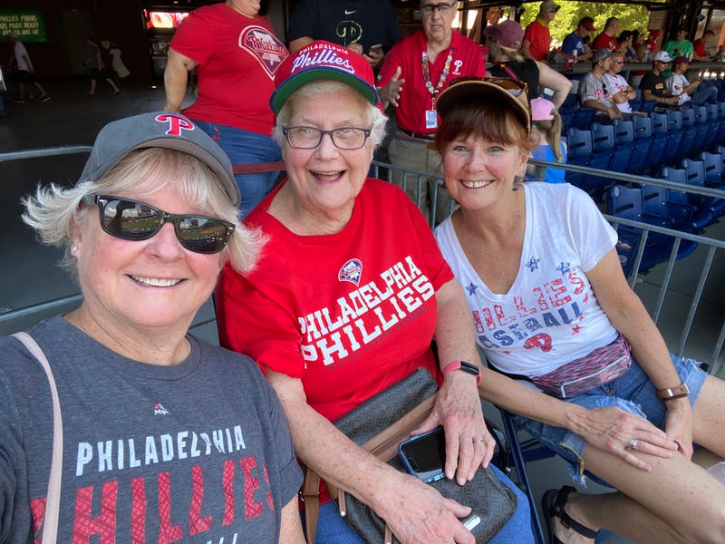 Three women at a baseball park