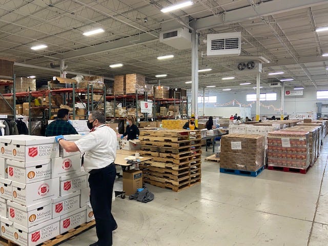 Volunteers were working in a warehouse in the northwest suburbs to pack thousands of boxes of food for needy families this Christmas.