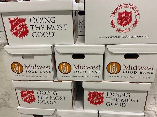 Volunteers were working in a warehouse in the northwest suburbs to pack thousands of boxes of food for needy families this Christmas.