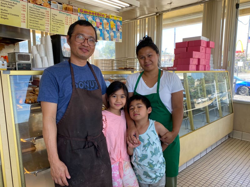couple with children in donut shop