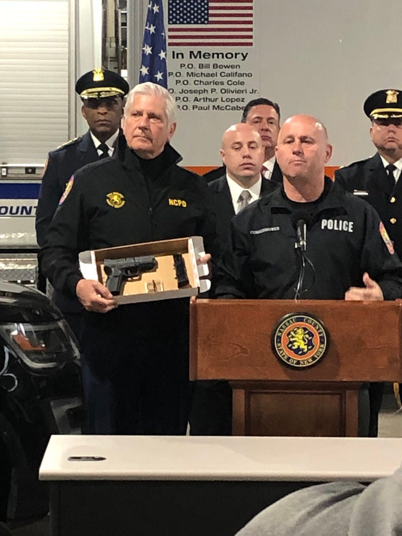 Police show off the handgun that they said was recovered from the stolen Mercedes