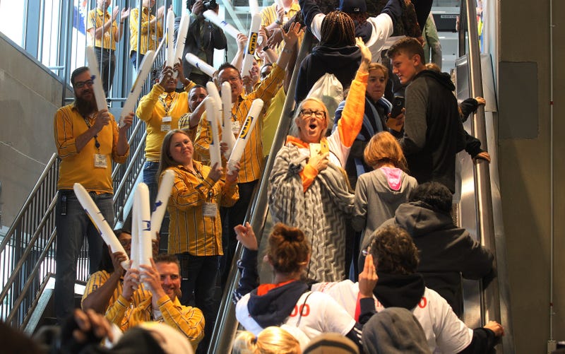Employees slap air sticks to welcome the first customers to their store during the grand opening of the 41st IKEA store in St. Louis on September 30, 2015.