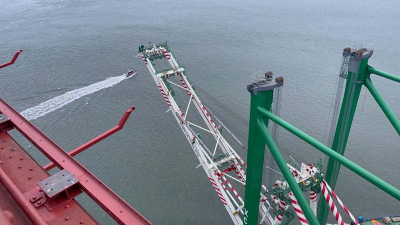The container crane passes under the Golden Gate Bridge early Thursday.