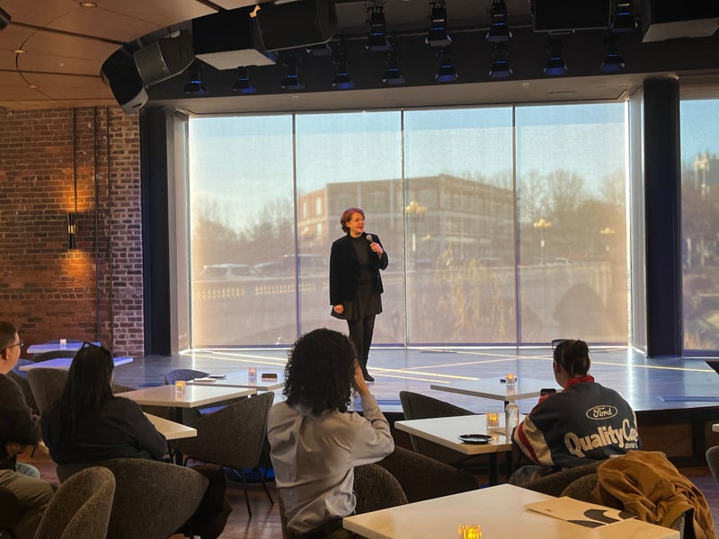 Peace Center CEO Megan Riegel speaks on the stage of the new "The Mockingbird on Main Street" venue