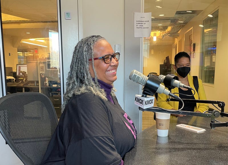marie franklin at kmox mic in studio. she is a black woman with gray dreads and a black shirt on