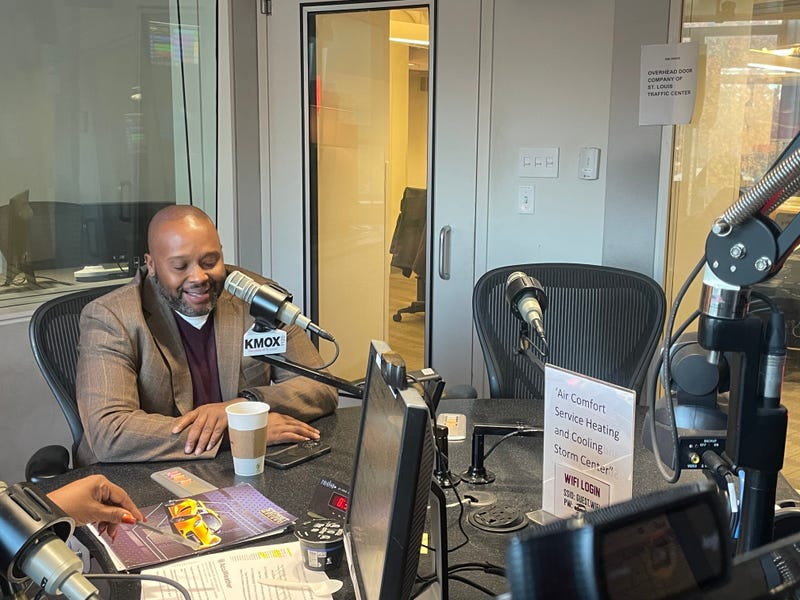 mayor robert eastern iii. he's a black man in a brown blazer speaking at a mic in the kmox studios