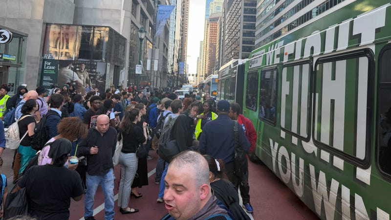 A crowd of confused commuters waits for shuttle buses after a power outage forces SEPTA to suspend subway lines around City Hall during the Wednesday evening rush.