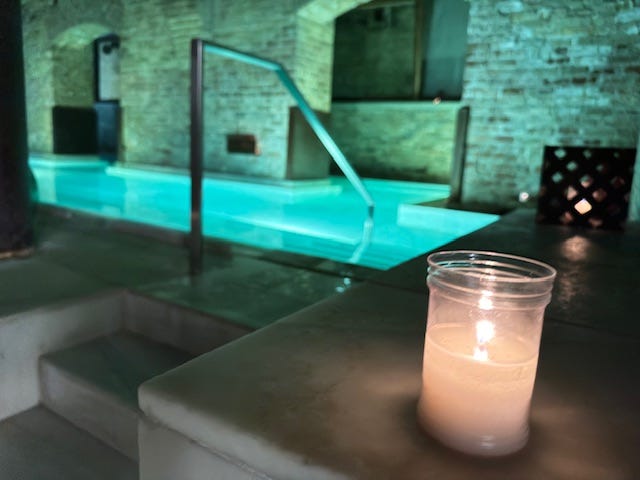 lit candle near spa at AIRE Ancient Baths