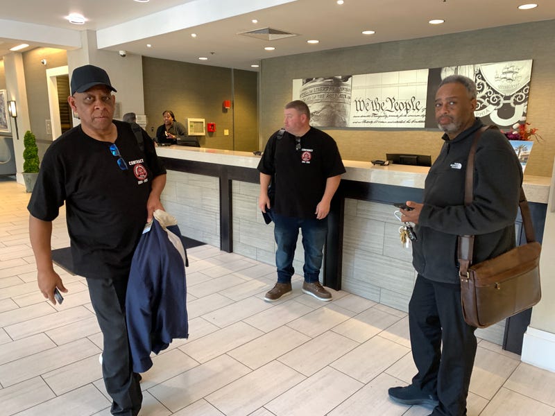 Local 234 president Brian Pollitt (far right) and negotiators arrive at the Wyndham Hotel in Old City for SEPTA contract talks.