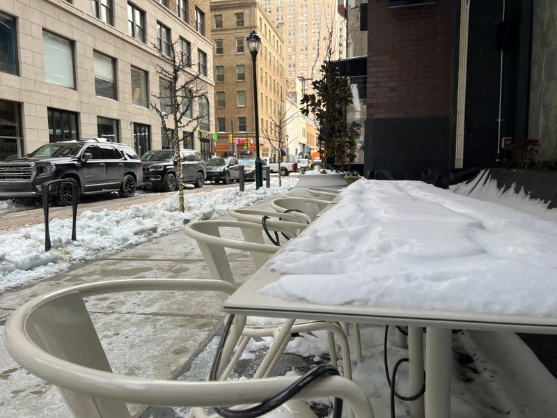 table and chairs covered in snow in Center City