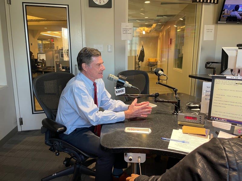dr. rick lehman in studio he's a white man grey hair button down red tie