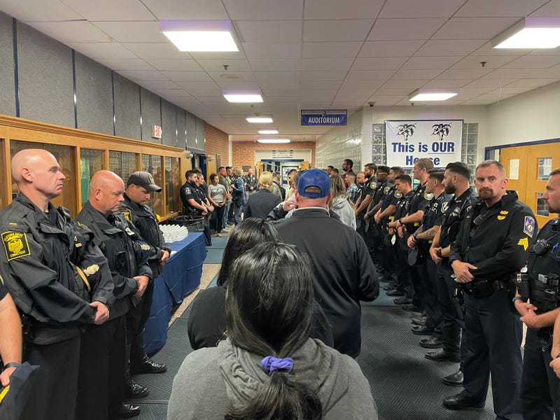 Bristol, CT residents enter the Bristol Eastern High School auditorium for a vigil in memory of two police officers, 10/13/22