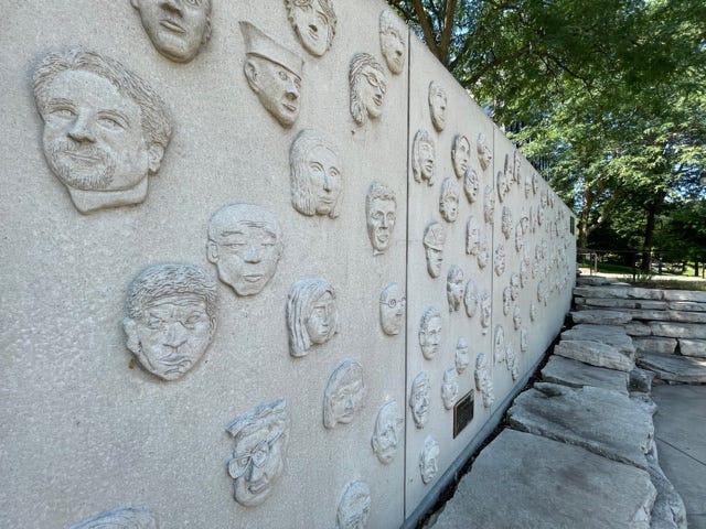 Shanower's boot print, a perennial garden, a bench, and a wall of faces make up the memorial at 400 South Eagle Street along the Riverwalk.