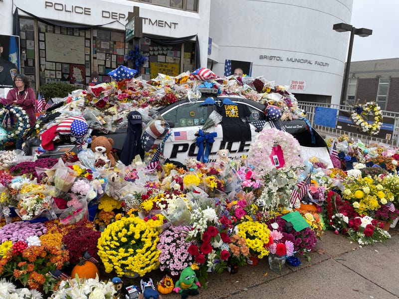 A memorial outside the Bristol Police Dept. for Lt. Dustin DeMonte and Sgt. Alex Hamzy, killed two weeks ago. Photo: 10/26/22