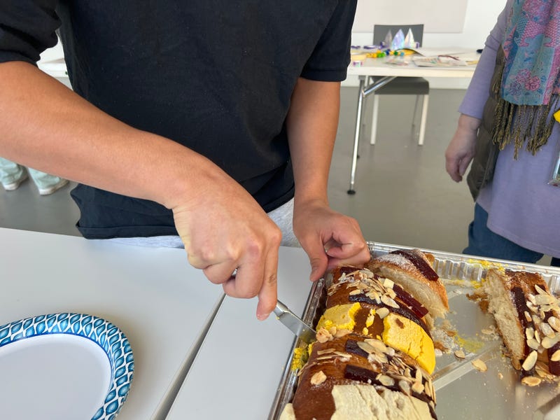 The celebratory cut of the Rosca de Reyes, or Three Kings Cake.