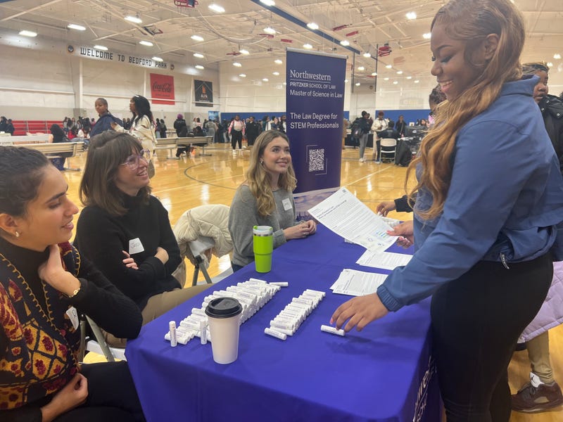 Crane Medical Prep High School Senior Rejonae speaks with representatives at CPS' second Women in STEM Career Fair. 