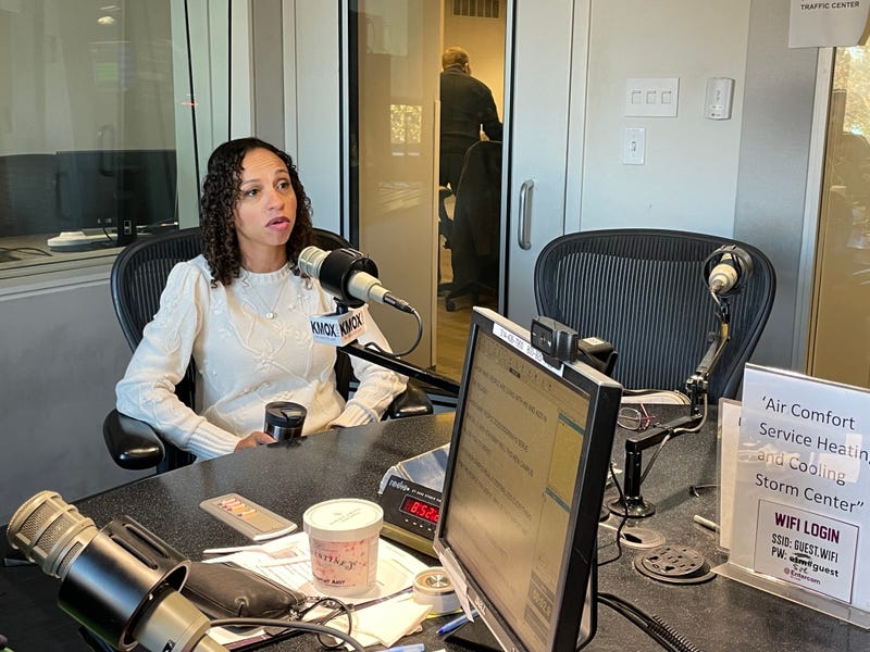 doorway's ceo opal jones in kmox studio. she has dark curly hair and a white sweater