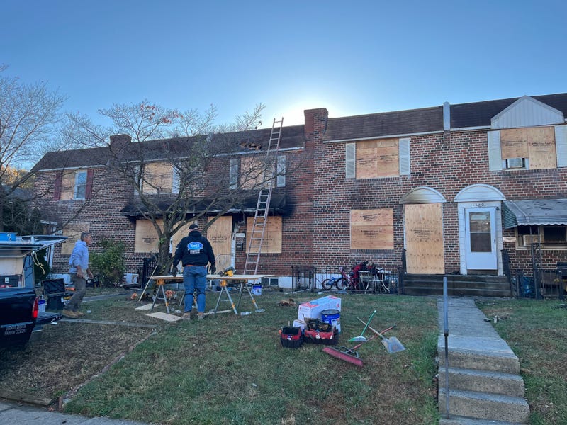 Burned out shells of homes are boarded up as neighbors in Folcroft, Delaware County, come together to get help to several families who have been displaced.