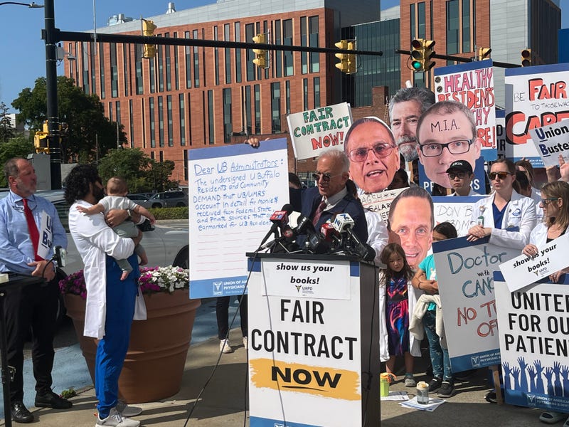 Dr. Gary Bussey holds up petition calling for transparency of our Buffalo healthcare systems. 
